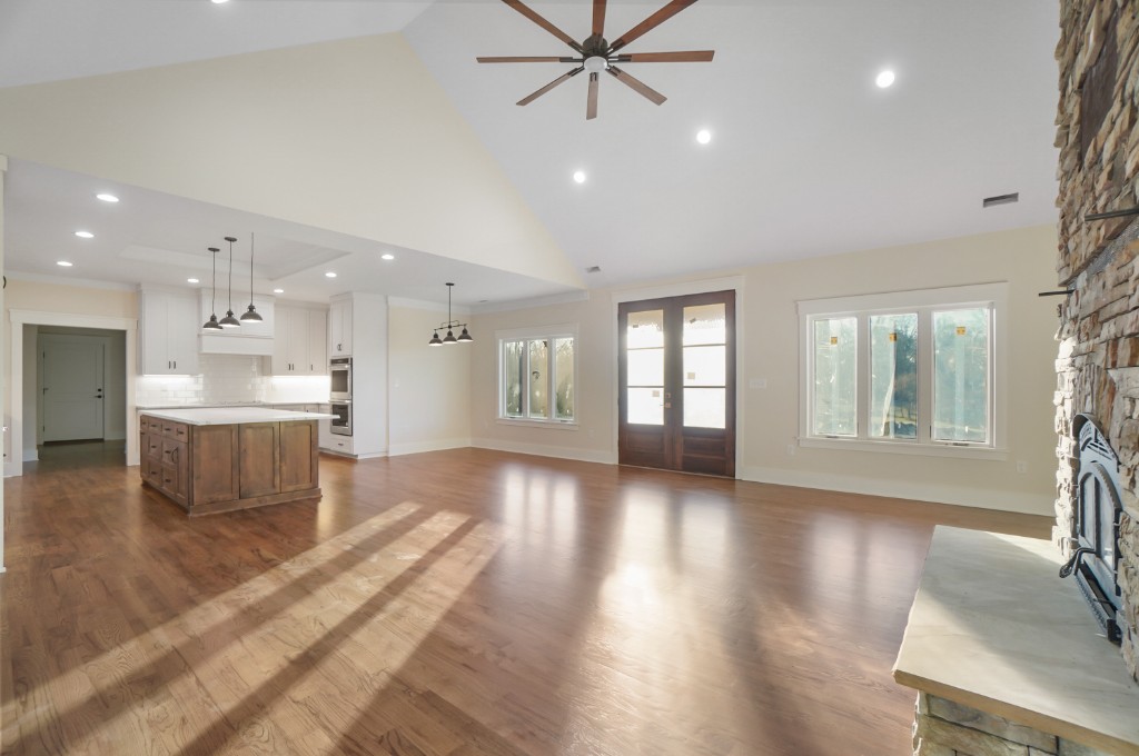 Open-concept kitchen and living with stone fireplace